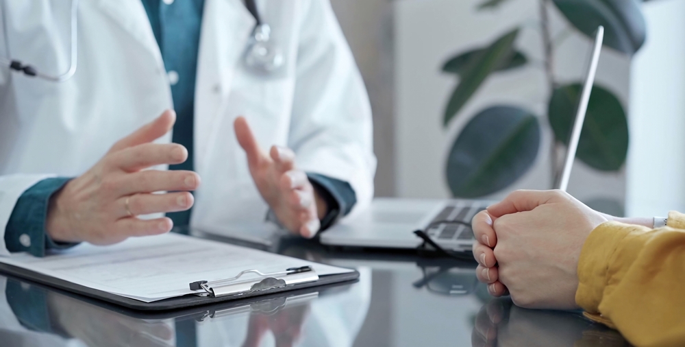 Doctor,And,Patient,Consultation,In,Clinic.,Patient,Listens,Attentively,As