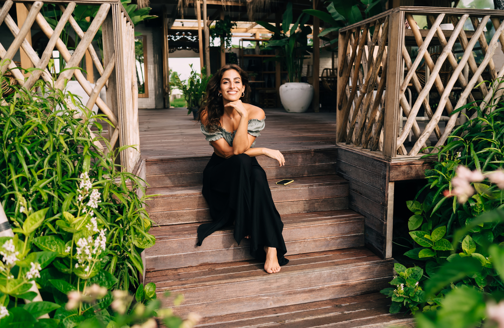 Positive,Barefoot,Female,In,Stylish,Outfit,Sitting,Alone,On,Steps