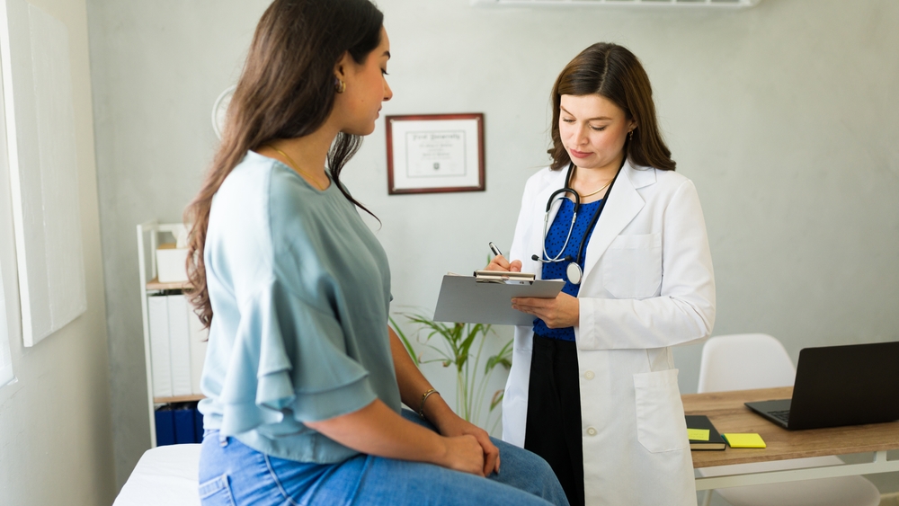 Caucasian,Doctor,Is,Carefully,Listening,To,Her,Patient,And,Taking