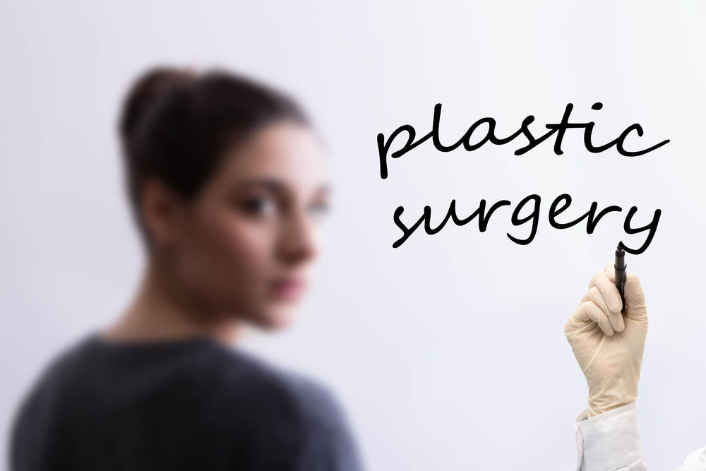 Blurred,Girl,In,Background,And,Hand,Writing,Plastic,Surgery